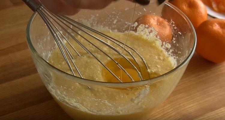 Add one egg to the oil mass.