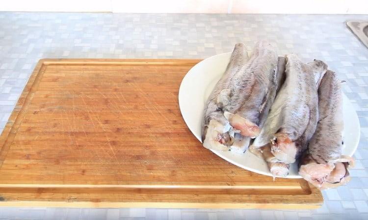 Gutted carcasses of pollock, cut off the tails.