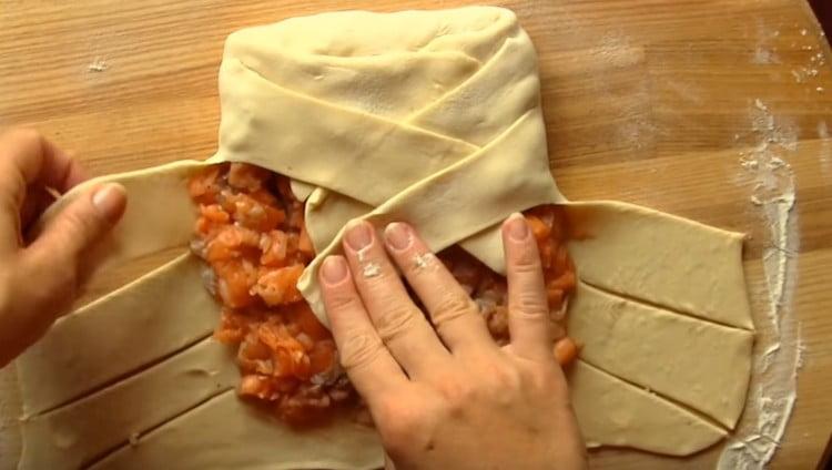 We braid the stripes of dough with a pigtail.