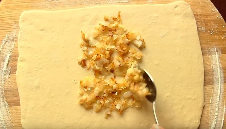 Put the onion on the center of the dough rectangle.