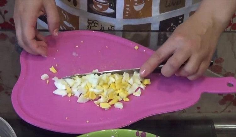Dice hard-boiled eggs.