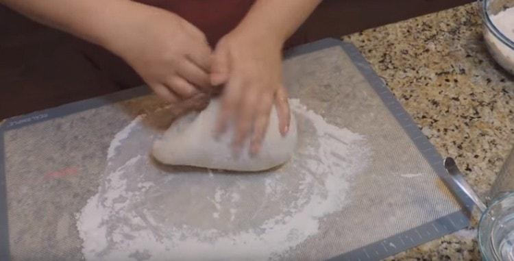 Knead the dough with your hands, adding flour.