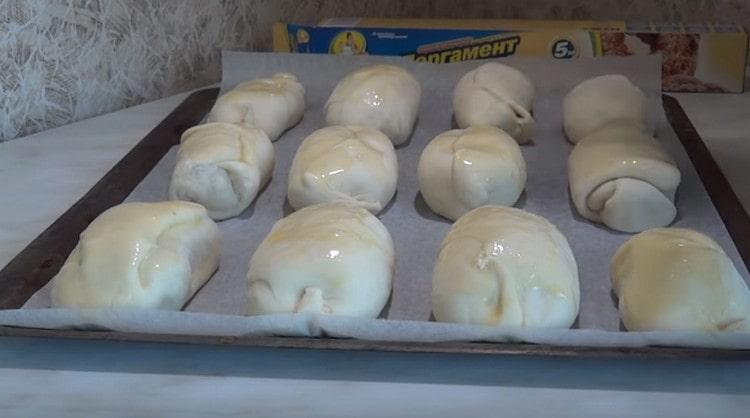 Before sending the pies to the oven, grease them with a beaten egg.