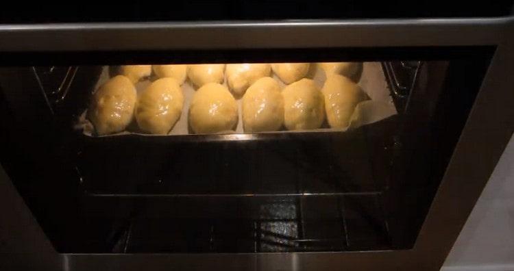 We send a baking tray with pies into the oven.