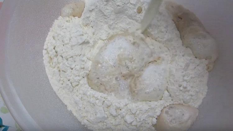 After a few minutes, the dough will rise, add warm milk to it.
