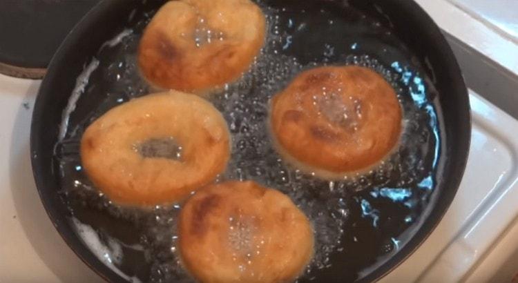Put dough pieces into boiling oil and fry on both sides.