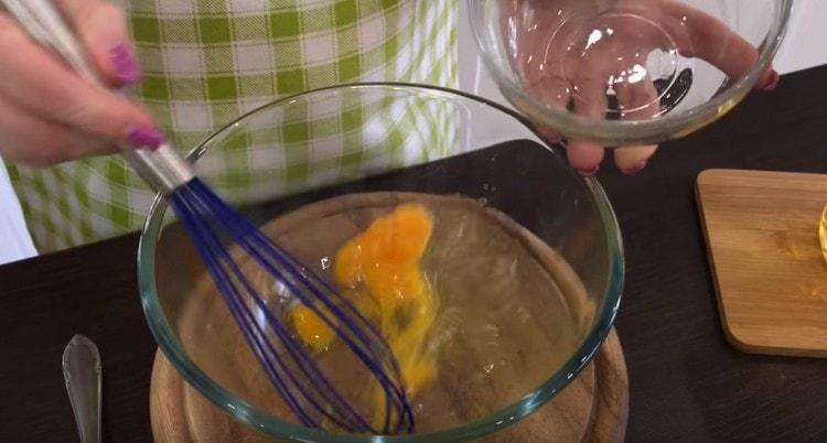 Beat the egg in a bowl.