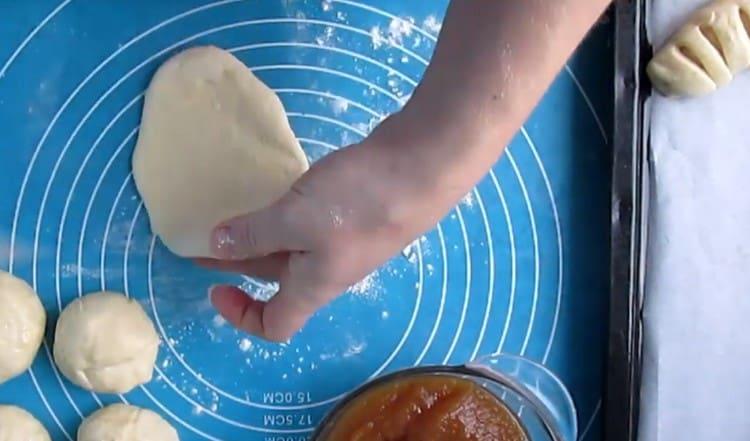 Roll the dough balls with a rolling pin into oblong flat cakes.