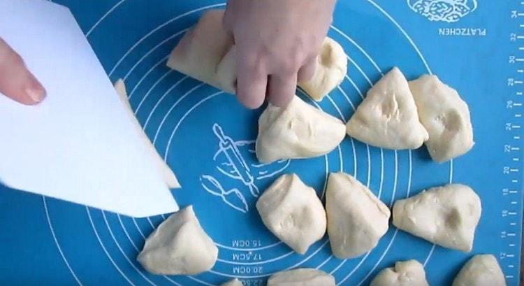 We crumble the risen dough and divide into portioned pieces.