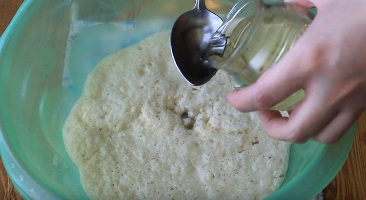 Add vegetable oil to the rising dough.