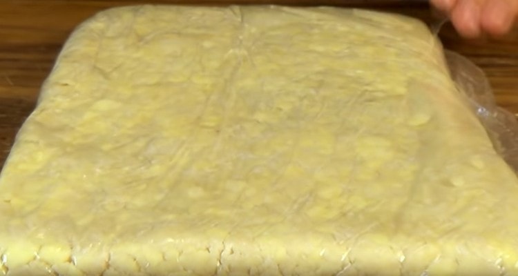 We collect the dough into a bag and ram into a rectangle.