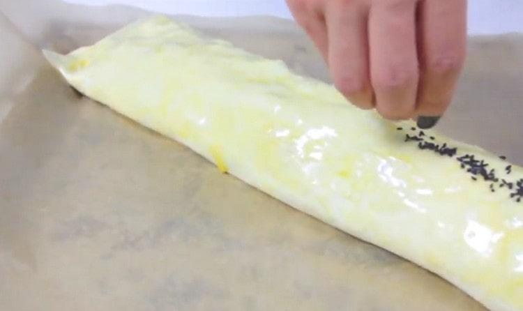 Sprinkle sesame roll.