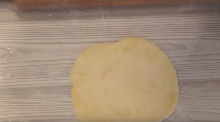 Roll out a piece of dough.