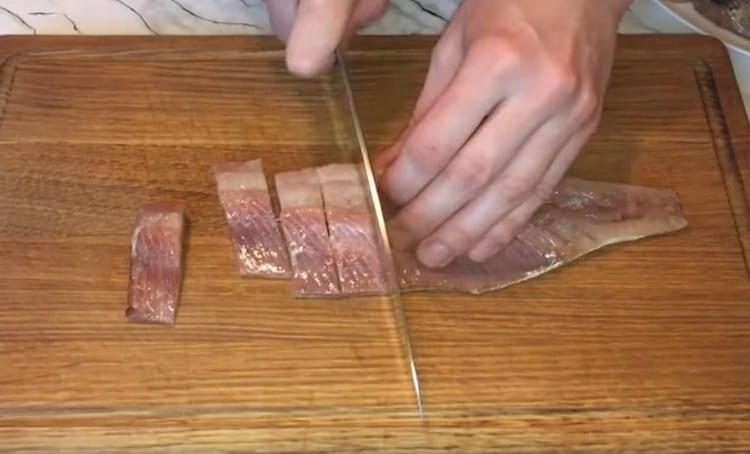 Cut herring fillet into pieces.
