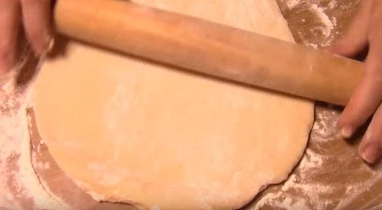 dividing the dough into several parts, we roll each of them into a circle.