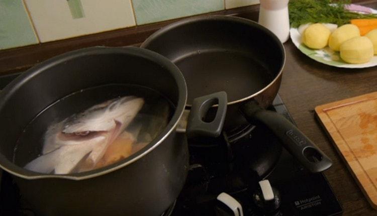Fill the fish in a pan with water and set to cook.