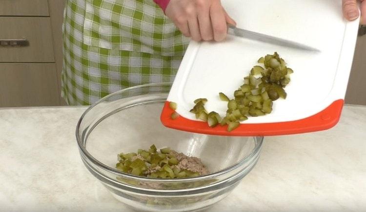 We chop finely pickled cucumbers and add cod to the liver.
