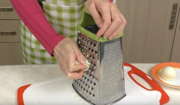 Grate boiled eggs.
