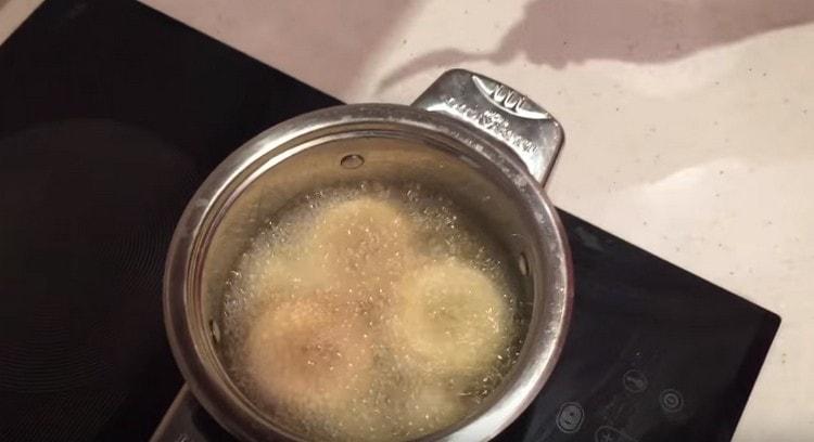 We spread the donuts and fry in boiling oil.