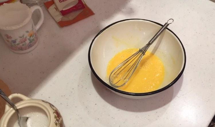 Beat the egg in a bowl.