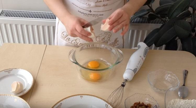 Eggs are beaten into a bowl.