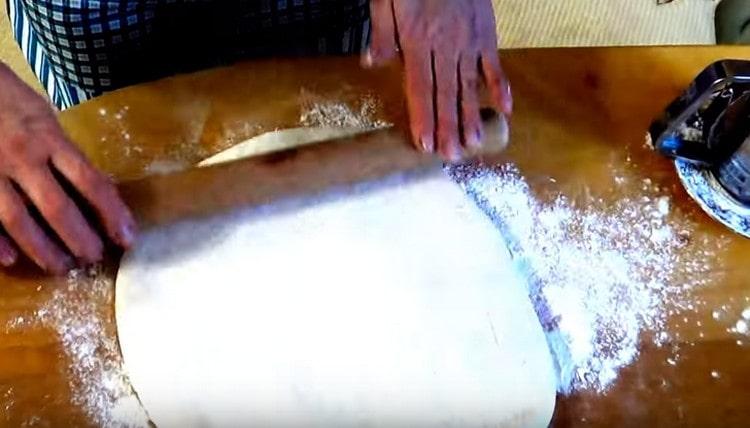 Roll out the dough into a rather large cake.