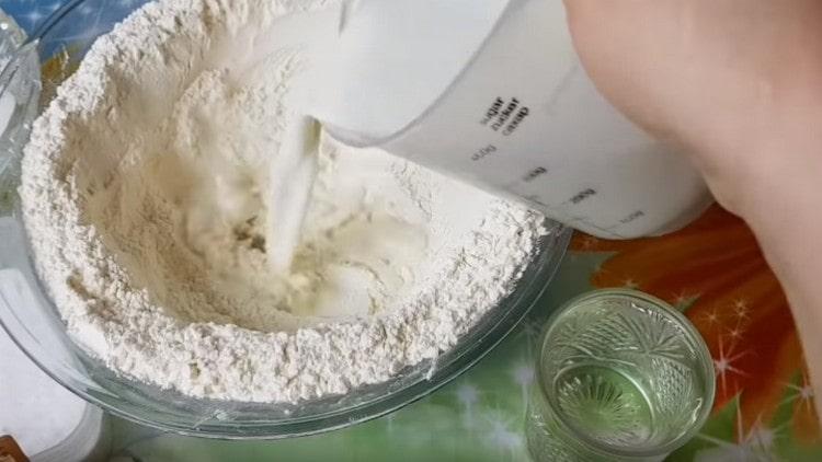 Sift the flour, make a depression in it, pour the milk.