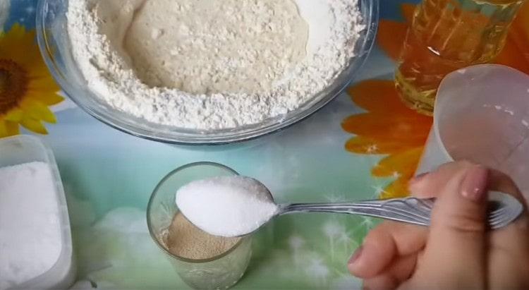 In warm water, stir yeast, sugar.