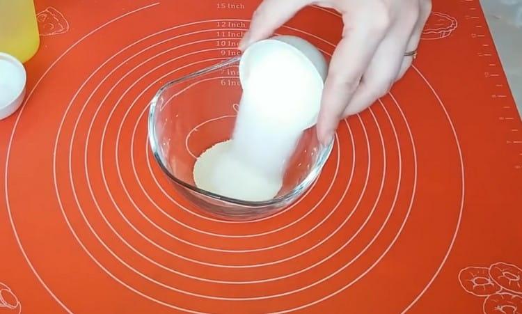 Pour sugar and yeast into a bowl.