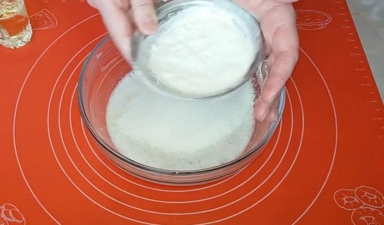 Sift flour into a bowl with yeast.