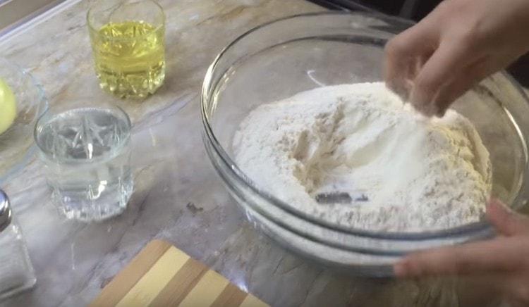 We sift the flour and make a depression in it.