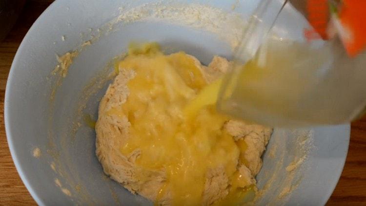 When the dough is gathered in a still sticky lump, add the melted butter.