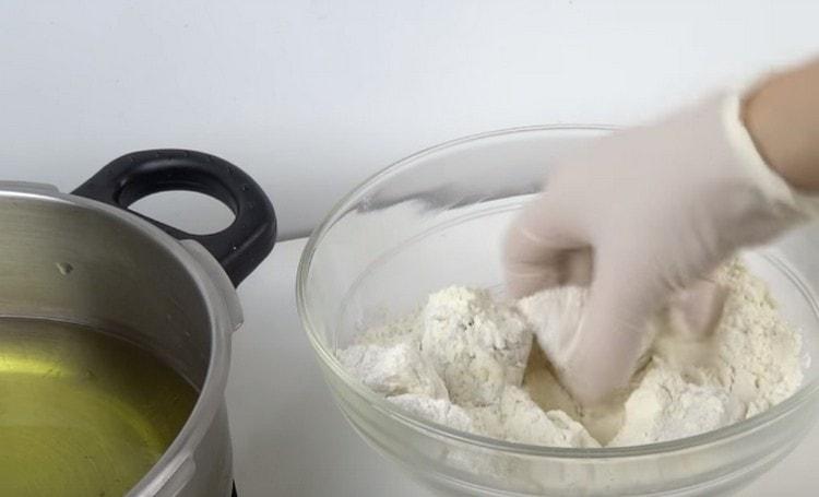 In a frying pan, heat the vegetable oil, and roll the fish in flour.