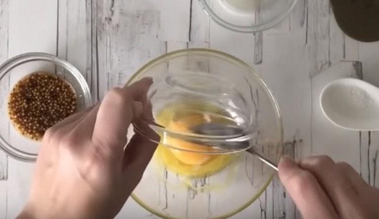 Add the egg yolk to the oil.