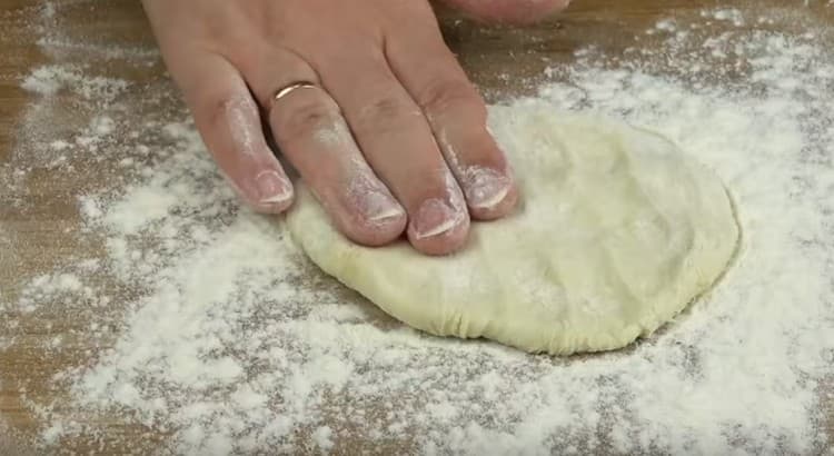 Knead each slice of dough into a flat cake.