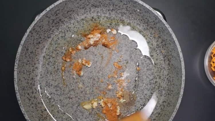 We heat vegetable oil in a pan and add spices to it.