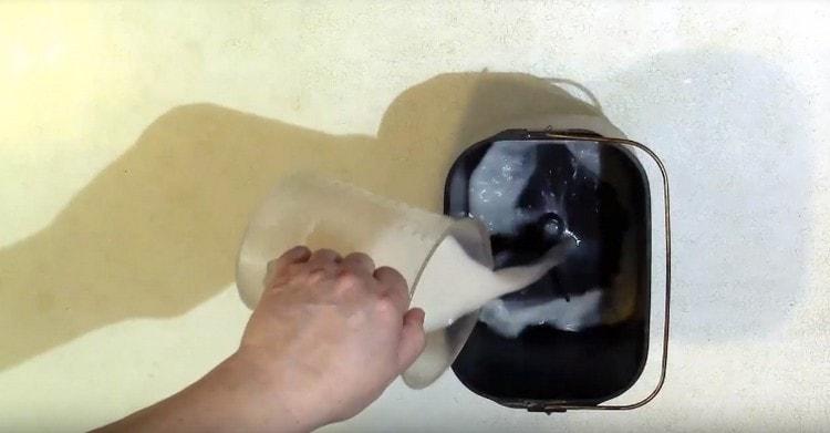 Pour the yeast mixture into a bucket of a bread machine.