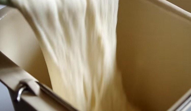 We spread the dough in a bucket of a bread machine.