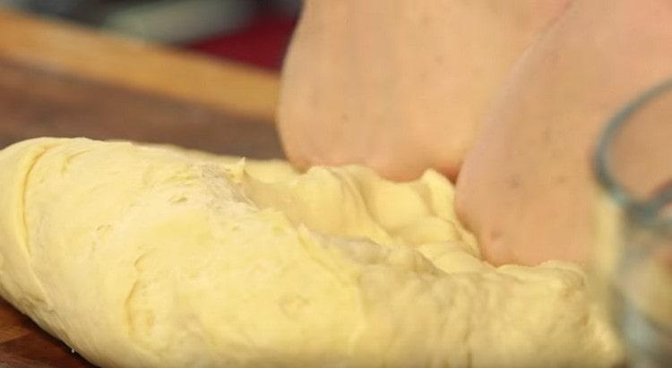 We knead the dough with our hands.