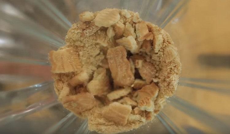 Grind shortbread cookies into crumbs.
