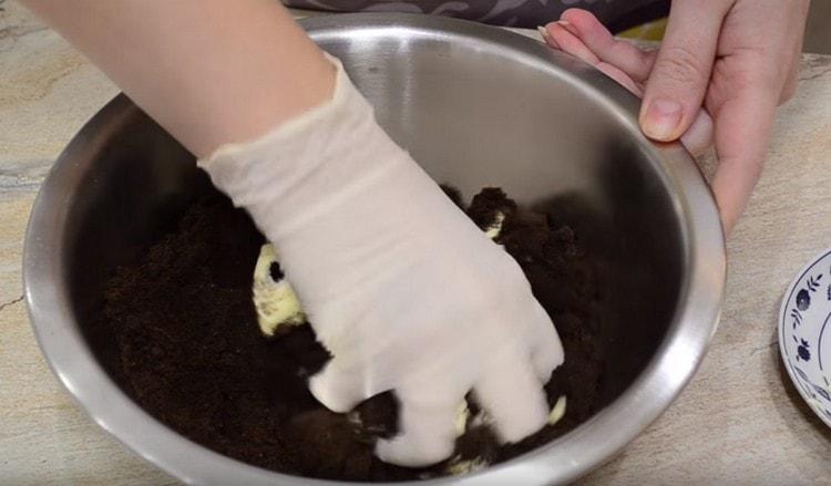 Add the butter to the remaining crumbs and mix