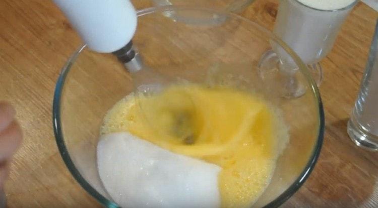 Add a glass of sugar to the eggs.