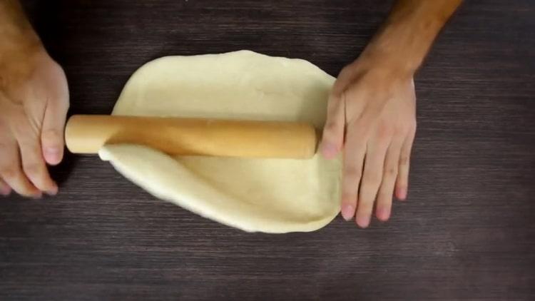 Roll dough to make poppy seed buns