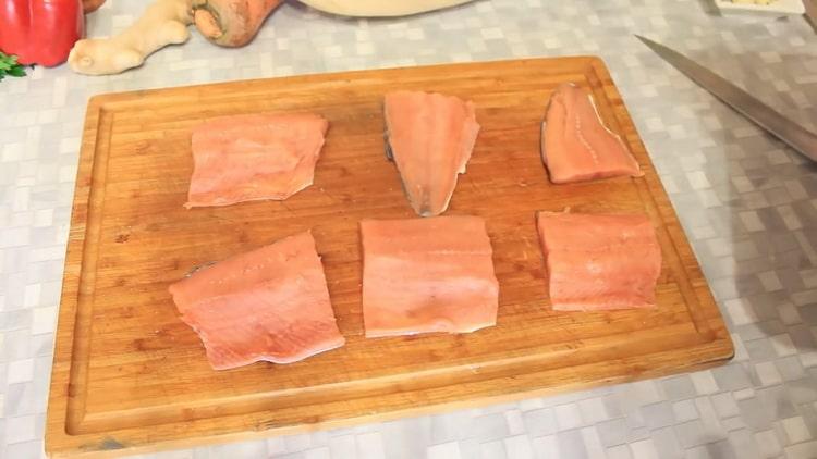 To cook pink salmon with vegetables in the oven, cut the fish