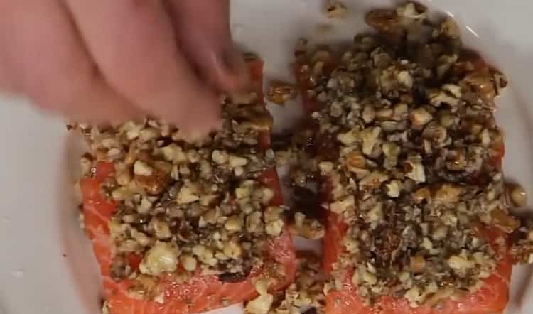 To cook red fish in the oven, lay the nuts on the fish