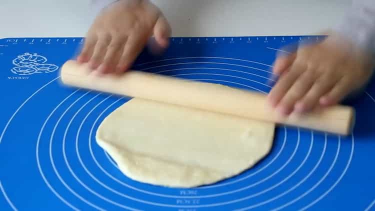 Roll out the dough to make flour tortillas in a pan