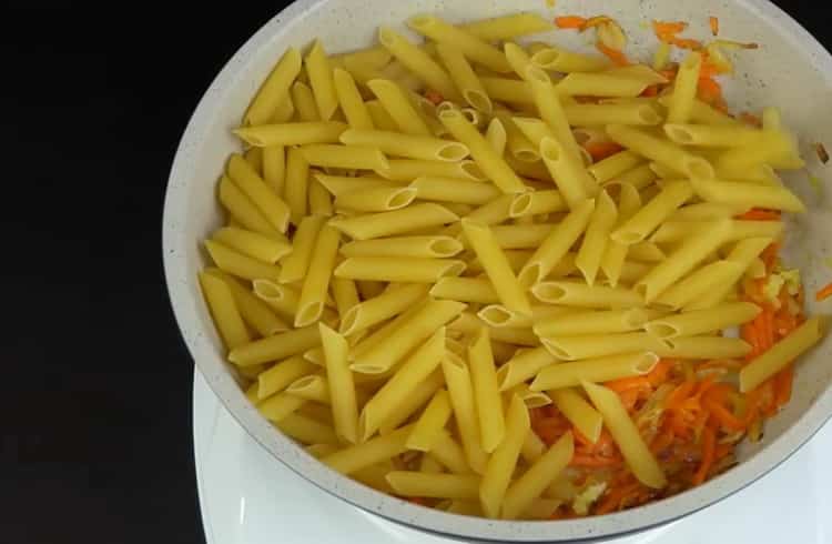 To cook pasta in a pan, put the pasta in a pan