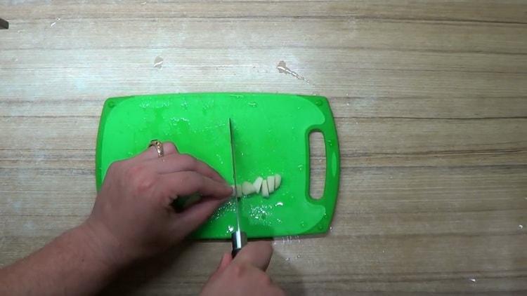 to cook perch in the oven in foil, chop the garlic