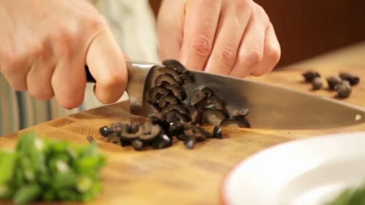 To make pasta with salmon, chop olives