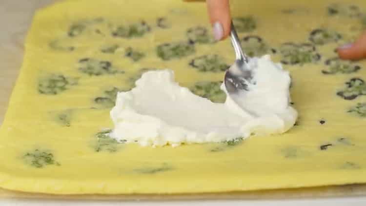 To make red fish roll, grease the dough with cheese